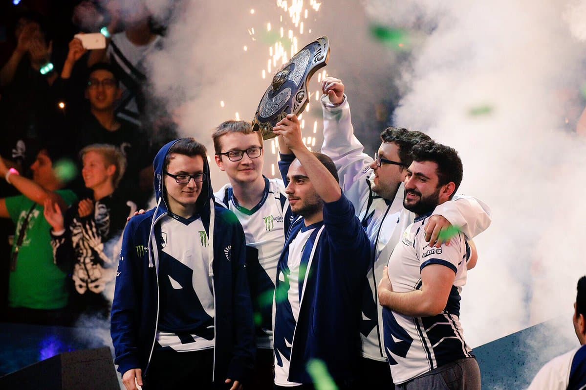 Matumbaman with Team Liquid lifting the Aegis at TI7